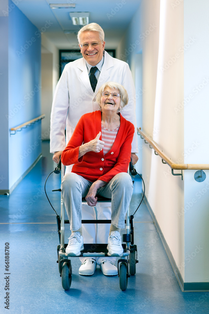 Doctor pushing an elderly woman in a wheelchair. Doctor pushing an elderly woman in a wheelchair.