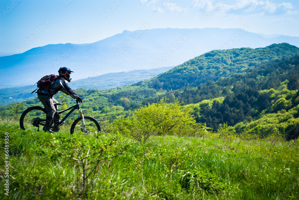 Fototapeta premium Dounhill rider in mountains