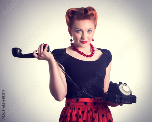 Cheerful woman talking on land line phone. photo