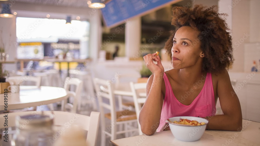 Girl eating french fries in restaurant Girl eating french fries in restaurant
