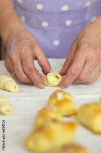 Baker making mini croissants, close up