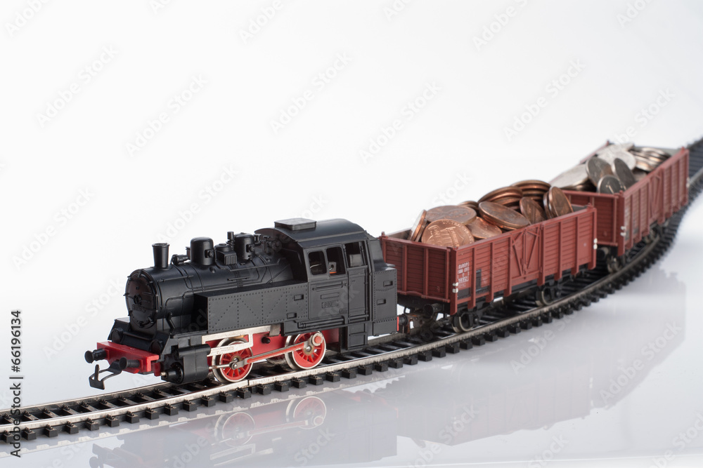 Fototapeta premium toy locomotive and coins