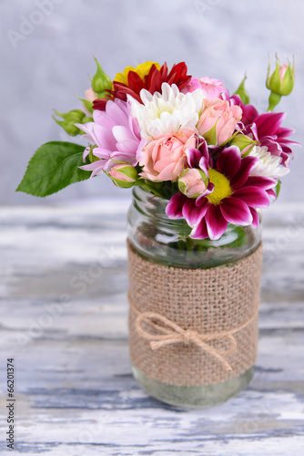 Fototapeta Naklejka Na Ścianę i Meble -  Beautiful bouquet of bright flowers in jar