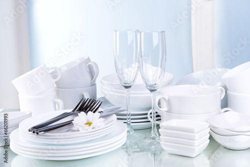Fototapeta Naklejka Na Ścianę i Meble -  Set of white dishes on table on light background