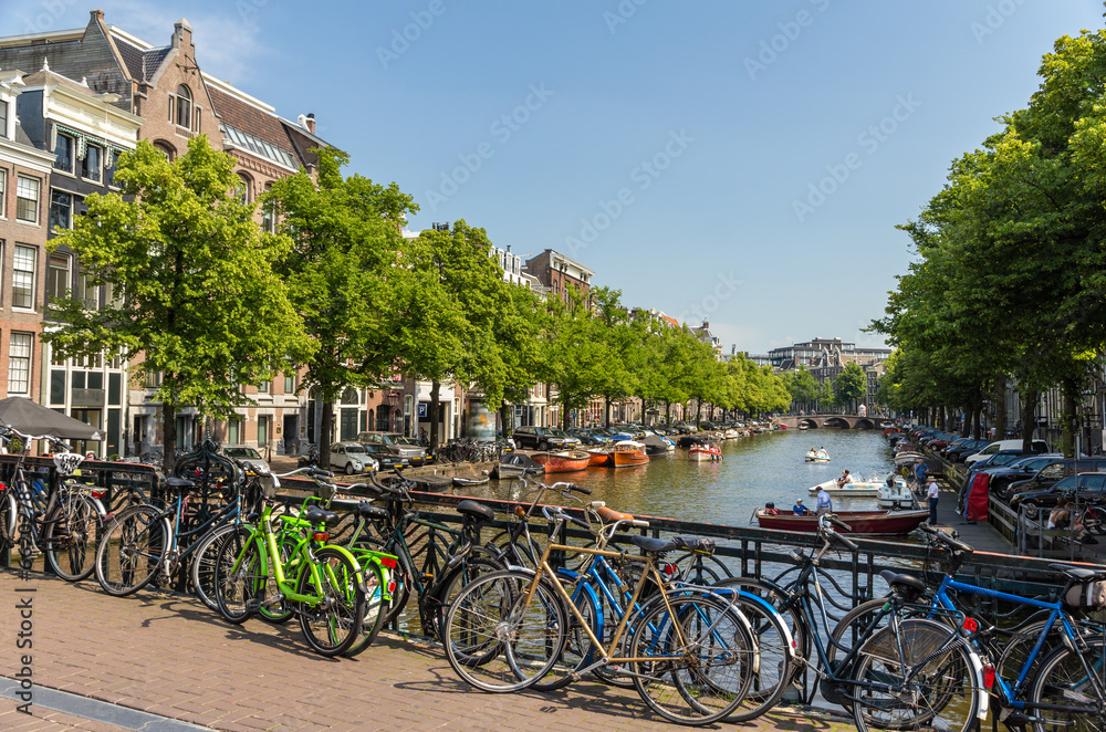 Fototapeta premium Traditional view of Amsterdam: bicycles and water