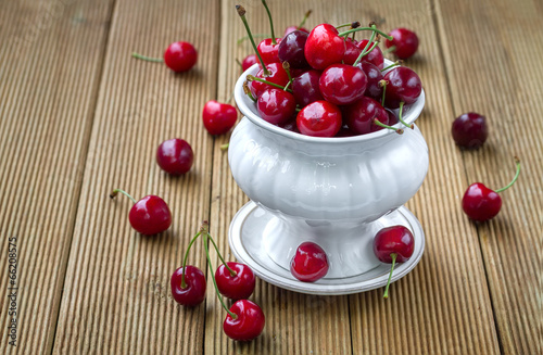 Ripe cherries on a wooden background