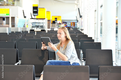 Girl with a tablet pc in the airport