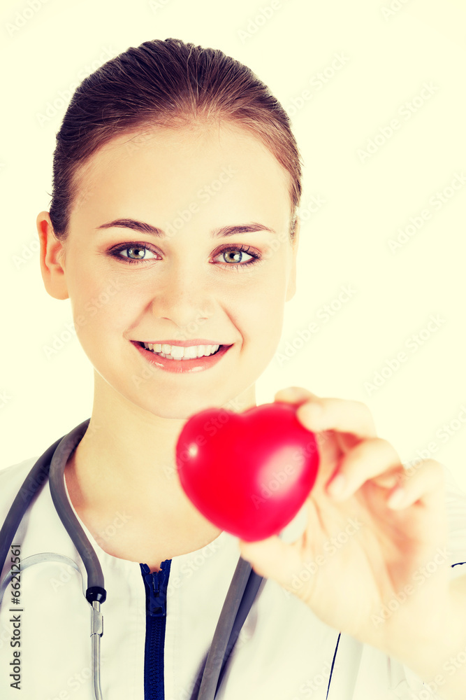 Young nurse with heart in her hand Young nurse with heart in her hand