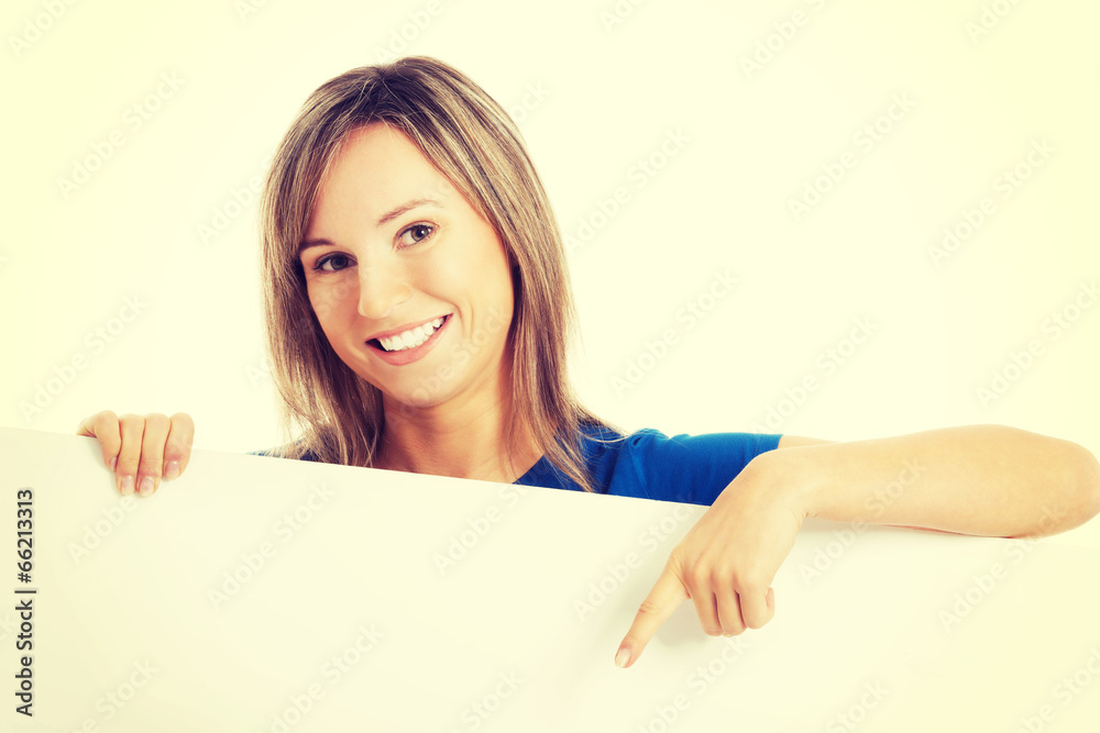 Casual beautiful woman pointing on copy space. Casual beautiful woman pointing on copy space.