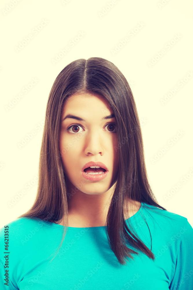 Young woman's portrait. She expresses shock.