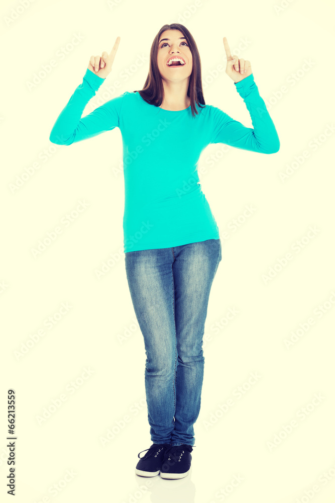 Beautiful casual woman pointing on copy space. Beautiful casual woman pointing on copy space.
