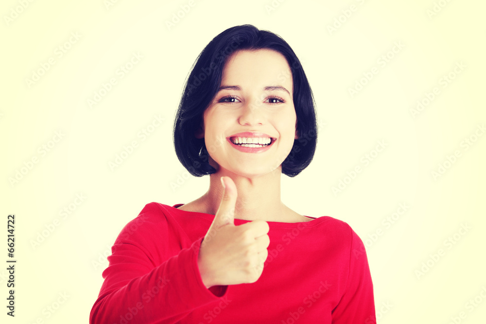 Beautiful young woman gesturing thumbs up. Beautiful young woman gesturing thumbs up.