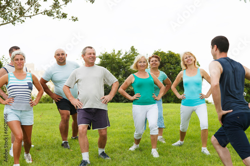 Active Mature People with fitness Trainer