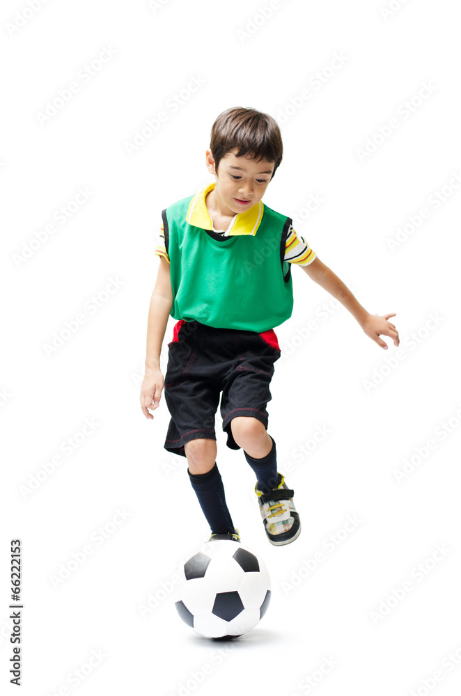 Little boy kicking football green on white background