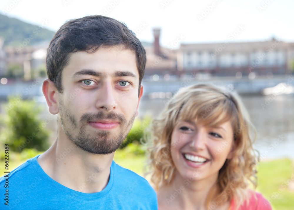 Smiling man with girl in the background