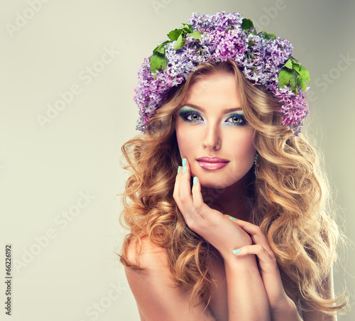 Fotografie Beautiful model of flowers lilac ,with curly long hair.
