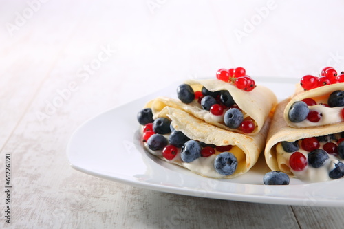 Pancakes with cream and fresh blueberries