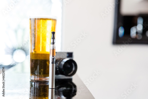 E-cigarette with a pint of beer and camera