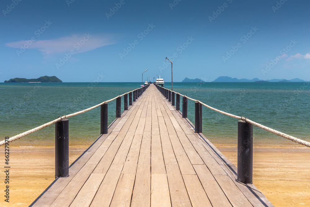 wooden bridge at a beautiful beach on sunny day