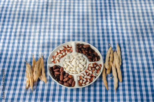 plate dried beans mix pod on checked tablecloth