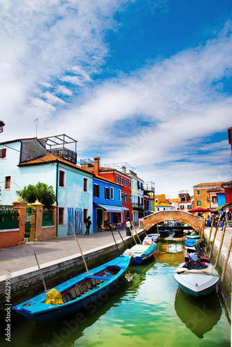 Venice, Burano island canal, small colored houses and the boat