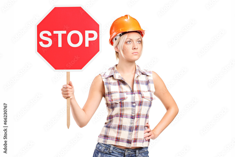 Female construction worker holding a stop sign Female construction worker holding a stop sign