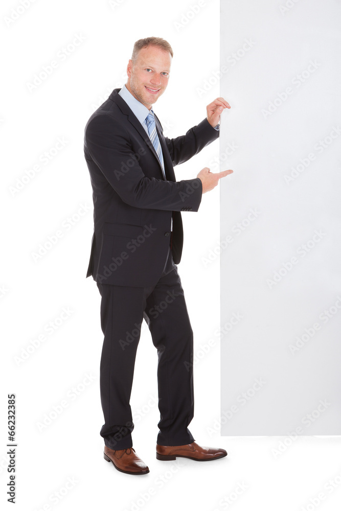 Confident Businessman Showing Billboard Confident Businessman Showing Billboard