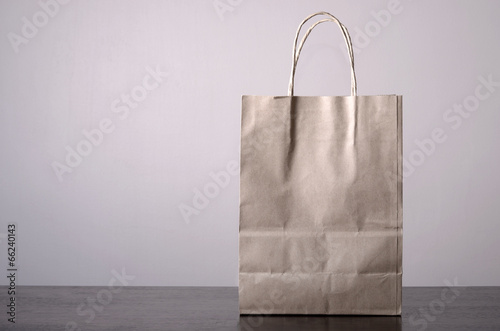 recycled paper bag on table with plain background