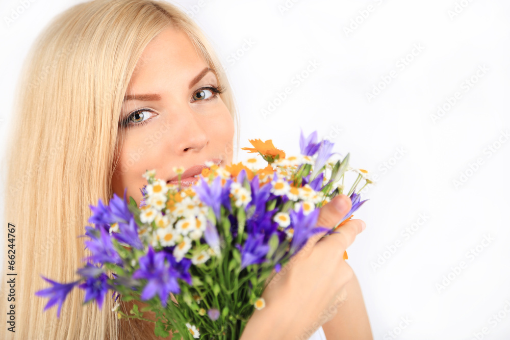 Young beautiful woman with flowers isolated on white