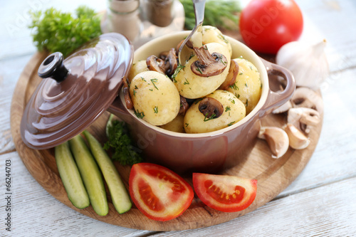 Young boiled potatoes in pan with vegetables