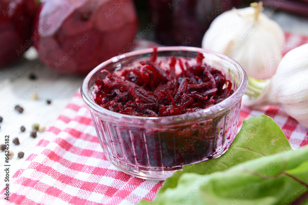Grated beetroots in bowl on table close-up Grated beetroots in bowl on table close-up