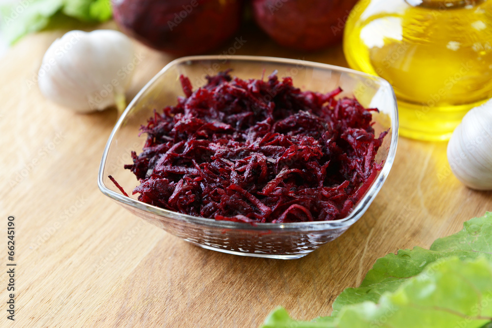 Grated beetroots in bowl on table close-up Grated beetroots in bowl on table close-up