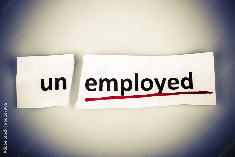 The word unemployed changed to employed on torn paper The word unemployed changed to employed on torn paper
