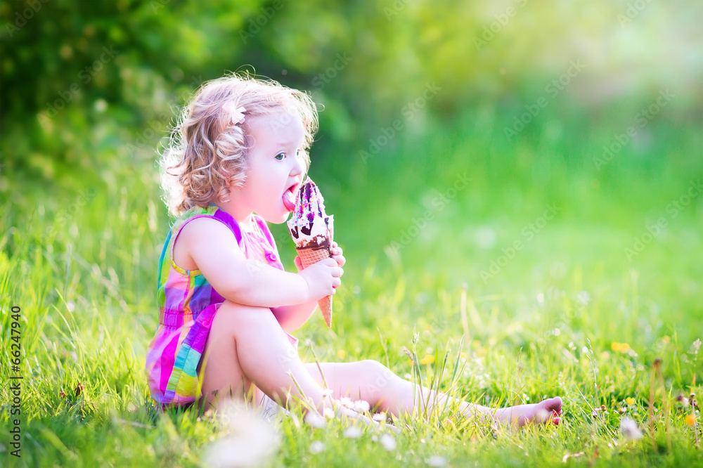 Funny girl eating ice cream in the garden Funny girl eating ice cream in the garden