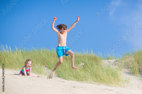 Kids playing in sand dunes