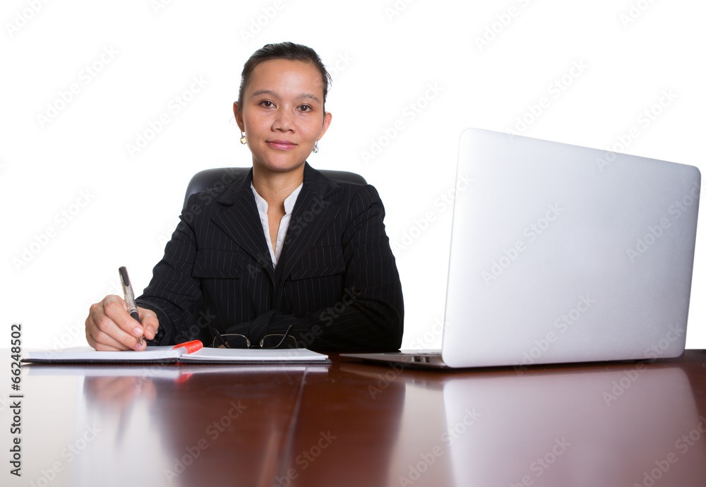 Asian businesswoman at her office desk over white background Asian businesswoman at her office desk over white background