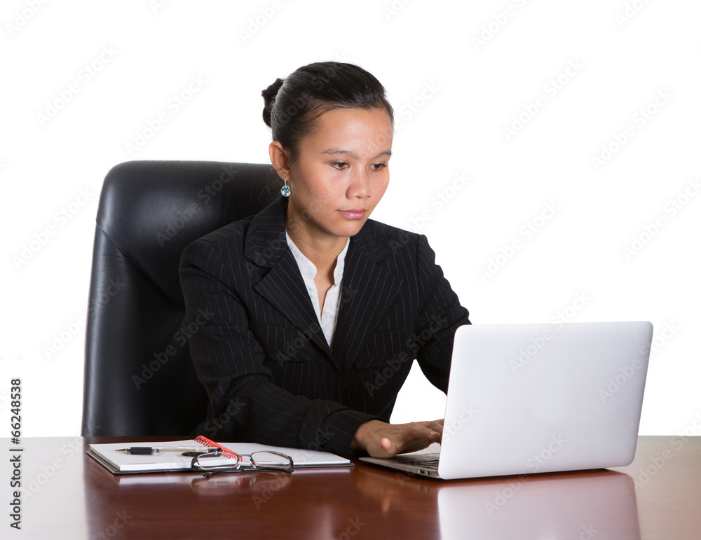Asian businesswoman at her office desk over white background Asian businesswoman at her office desk over white background