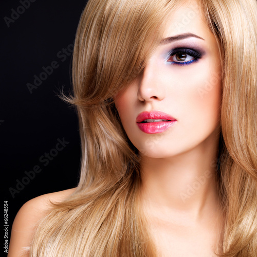 Closeup portrait of a beautiful young woman with long white hair