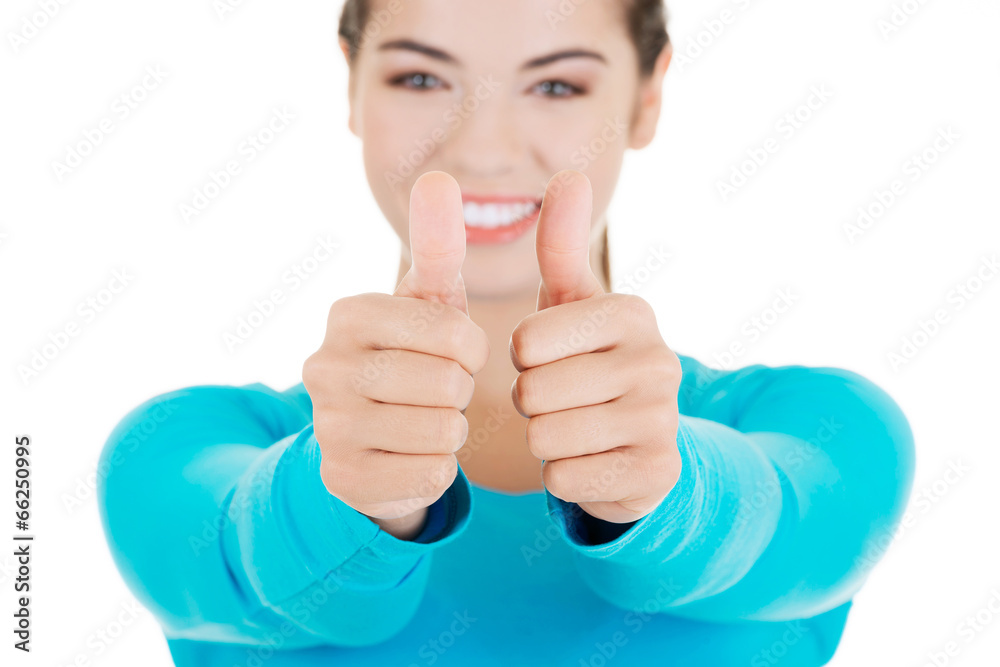 Teen woman gesturing thumbs up