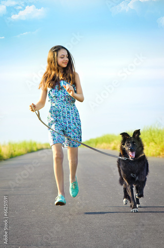 Girl with a dog for a walk