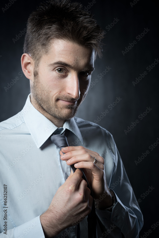 Adjusting necktie Adjusting necktie