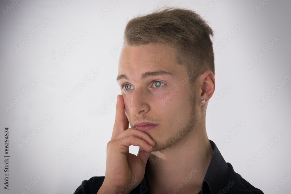 Attractive young man thinking, looking away Attractive young man thinking, looking away