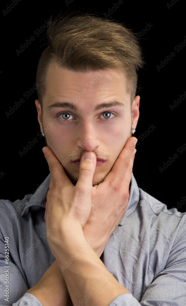 Attractive blond young man, serious expression Attractive blond young man, serious expression
