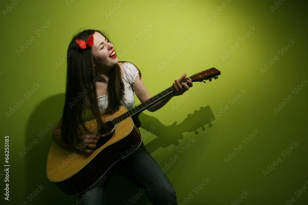 Brunette wildly playing guitar