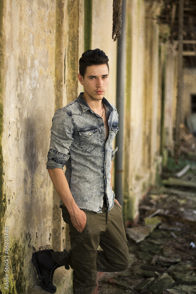 Handsome young man in abandoned, run down building Handsome young man in abandoned, run down building