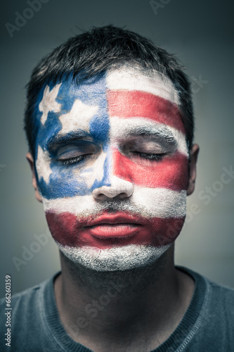 Man with USA flag on face and closed eyes