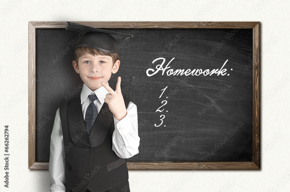 Cheerful little boy on blackboard. Looking at camera Cheerful little boy on blackboard. Looking at camera
