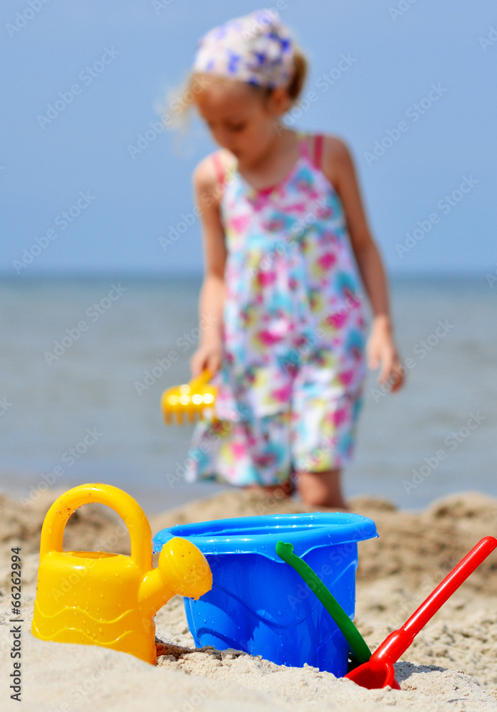 Little girl playing on the sand beach Little girl playing on the sand beach
