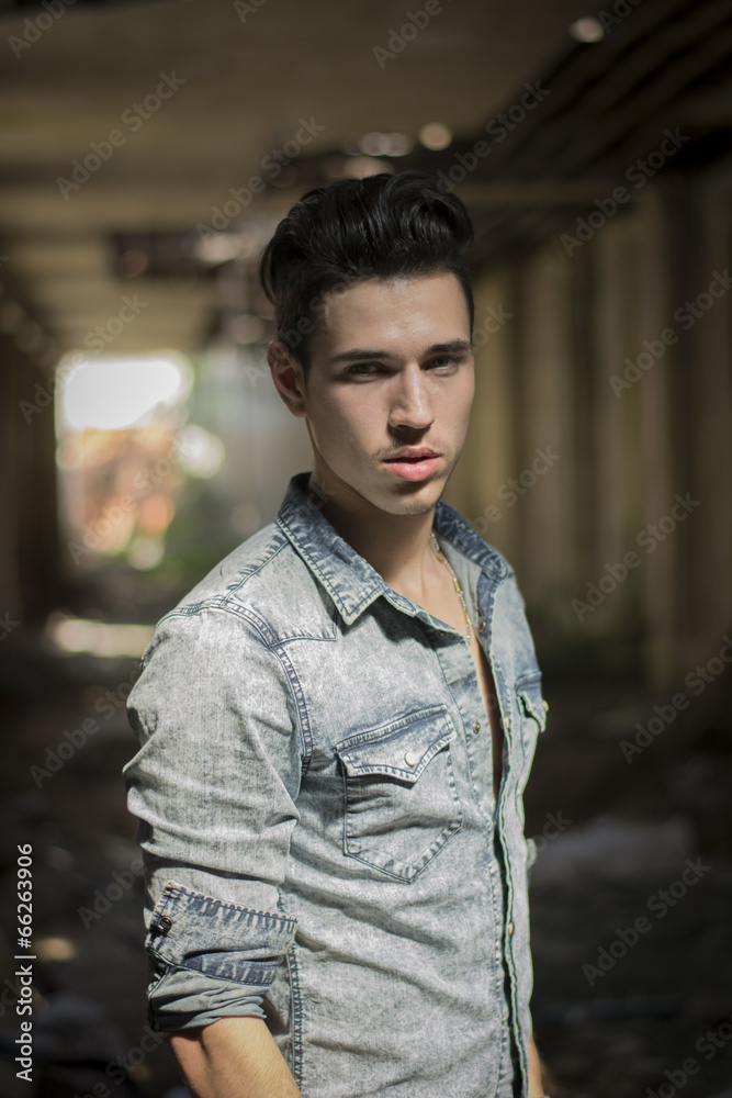 Handsome black haired young man in denim shirt Handsome black haired young man in denim shirt