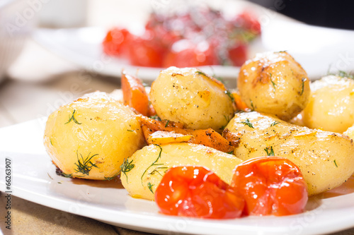 Roasted potatoes with carrot and tomatoes